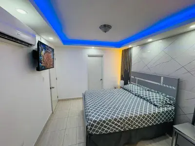 a bedroom with a bed with a blue ceiling at Joel Arturo Residences in Licey al Medio