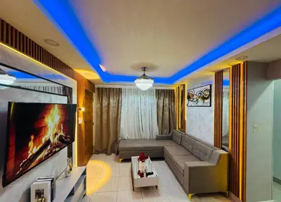 a living room with a couch and a flat screen tv at Joel Arturo Residences in Licey al Medio