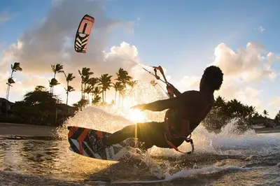 a man riding a kite board in the water at Villa Palmas Doradas in Cabarete