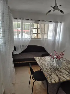 a living room with a couch and a table at R.G sol 2 in Pantoja