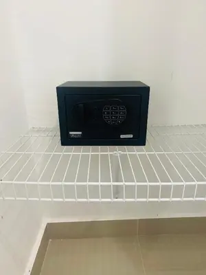 a black microwave sitting on top of a shelf at Confortable y lujoso apartamento en santiago in Santiago de los Caballeros
