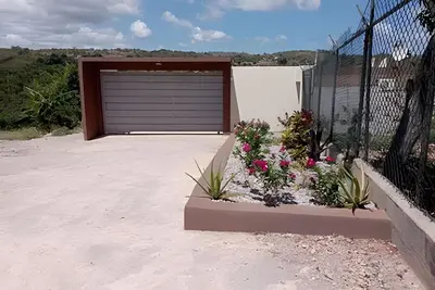 a garage door with flowers in front of it at Apart hotel Costa Verde Exclusivo y Seguro #5 con cama Queen in Las Galeras