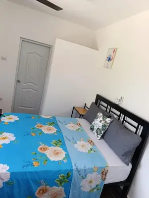 a bedroom with a bed with a blue comforter at Apart hotel Costa Verde Exclusivo y Seguro #5 con cama Queen in Las Galeras