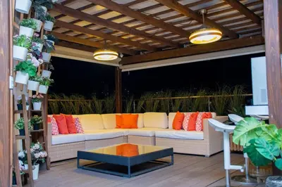 a patio with a white couch and orange pillows at 8BR Penthouse Jacuzzi, Pool Table Terrace in Los Prados