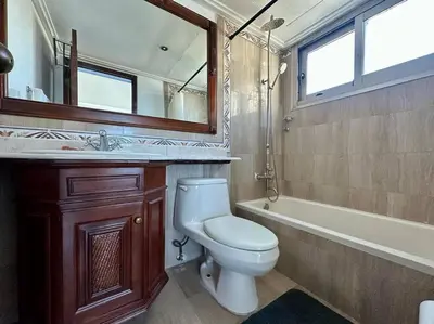 a bathroom with a toilet and a sink and a tub at 3 BDR Ocean View luxury Apartment . Sleeps 6 in Santo Domingo