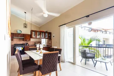 a kitchen and dining room with a table and chairs at Novus Mare, Cabarete center! in Cabarete
