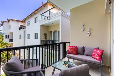 a balcony with two couches and a table at Novus Mare, Cabarete center! in Cabarete