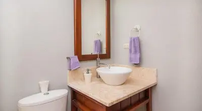 a bathroom with a sink and a toilet and a mirror at A pasos de la playa cerca de bares y restaurantes in Punta Cana