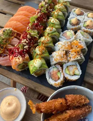 a tray of sushi and other foods on a table at VILLA GRANDEZZA in Punta Cana