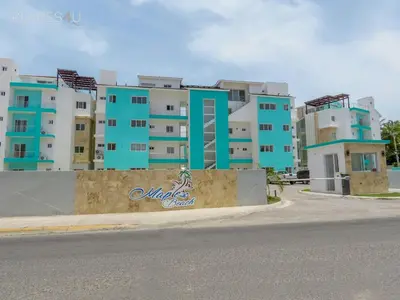 a row of apartment buildings on the side of a street at Cerca de la playa y restaurantes espacio relajante in Punta Cana