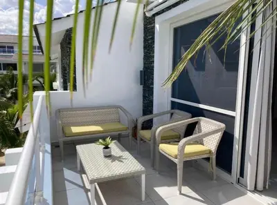 a porch with two chairs and a table and chairs at Luxury Apartment Dominicus in La Laguna