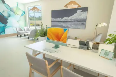 a desk with a computer monitor on top of it at Wyndham Garden El Morro Montecristi in El Rincón