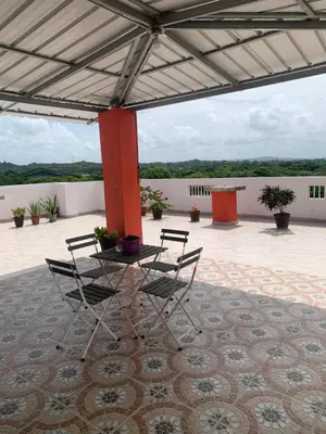 a patio with a table and chairs on a patio at Plataview Apartahotel 3B in Monte Plata