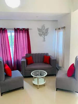 a living room with a couch and two chairs and a table at Plataview Apartahotel 3B in Monte Plata