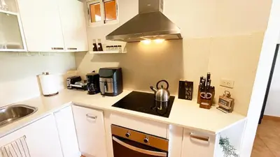 a small kitchen with a sink and a stove at Cozy apartment Golf Course View in Punta Cana in Punta Cana