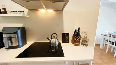 a tea kettle sitting on top of a stove in a kitchen at Cozy apartment Golf Course View in Punta Cana in Punta Cana