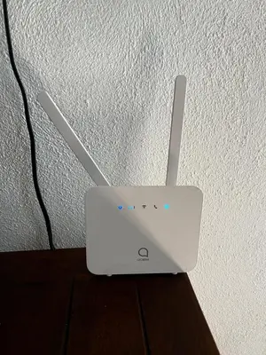 a white router sitting on top of a table at Villa unter Palmen in Jarabacoa