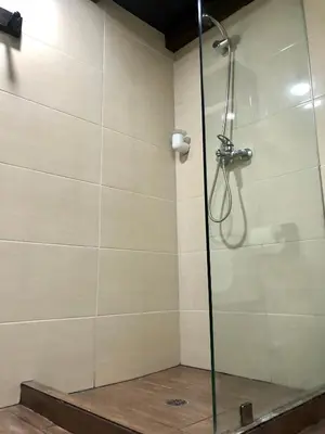 a shower with a glass door in a bathroom at MOKA HOUSE in Santo Domingo