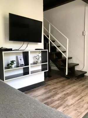 a living room with a flat screen tv on a wall at MOKA HOUSE in Santo Domingo