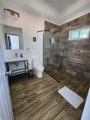 a bathroom with a shower and a toilet and a sink at Bella Villa room with large pool and close to beach in Las Galeras