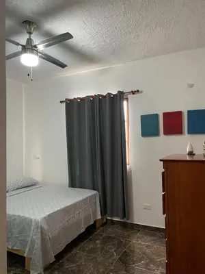 a bedroom with a bed and a ceiling fan at Casa Jacaranda -10 pax, Cerca de la Playa in Las Galeras
