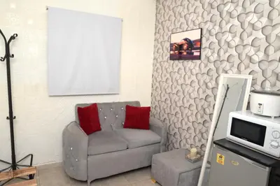 a living room with a couch and a tv at APARTAMENTOS DE 1 2 Y 3 HABITACIONEs in Santiago de los Caballeros