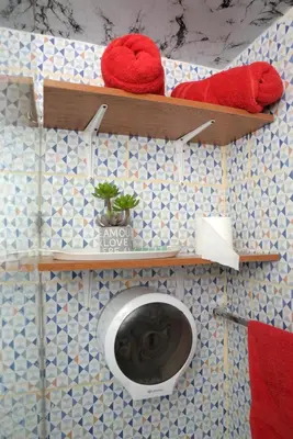 a bathroom with a toilet on a tiled wall at APARTAMENTOS DE 1 2 Y 3 HABITACIONEs in Santiago de los Caballeros