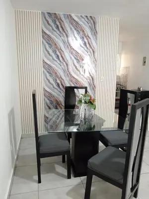 a dining room with a glass table and chairs at APARTAMENTOS DE 1 2 Y 3 HABITACIONEs in Santiago de los Caballeros