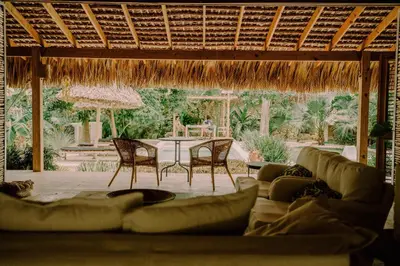 a living room with couches and a table and chairs at Buena Vida Macao 7 habitaciones in Salado