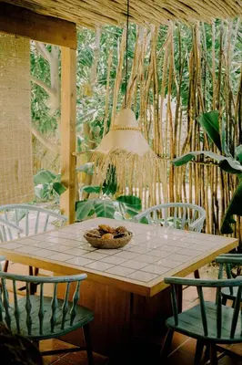 a table with chairs and a bowl of food on it at Buena Vida Macao 7 habitaciones in Salado