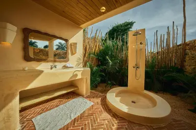 a bathroom with a toilet and a sink and a mirror at Buena Vida Macao 7 habitaciones in Salado