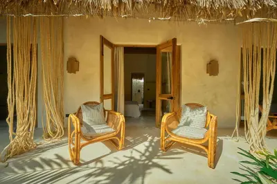 a room with two chairs and a mirror at Buena Vida Macao 7 habitaciones in Salado