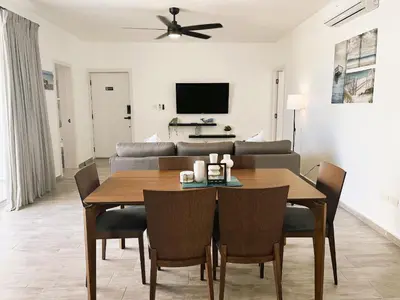 a living room with a table and a couch at Arena Village | 2H Retiro con Vista a Piscina in Punta Cana