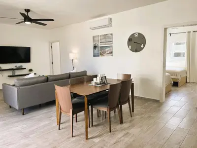a living room with a table and a couch at Arena Village | 2H Retiro con Vista a Piscina in Punta Cana