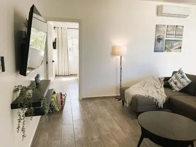 a living room with a couch and a table at Arena Village | 2H Retiro con Vista a Piscina in Punta Cana
