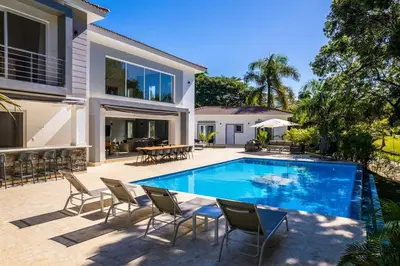a swimming pool in the backyard of a house at Villa Collie Luxury Retreat7 King Master BRMaid in Sosúa