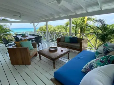 a living room with a couch and chairs on a deck at Spectacular Cozy Sea View Staffed Villa in Las Terrenas