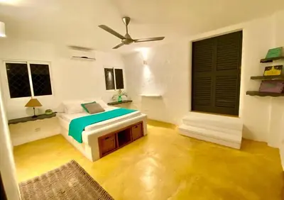 a bedroom with a bed and a ceiling fan at Spectacular Cozy Sea View Staffed Villa in Las Terrenas