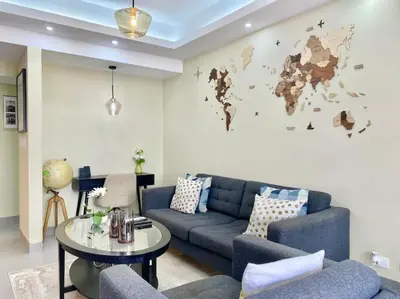 a living room with a blue couch and a table at Cozy City Center Condo, Full AC in Los Prados
