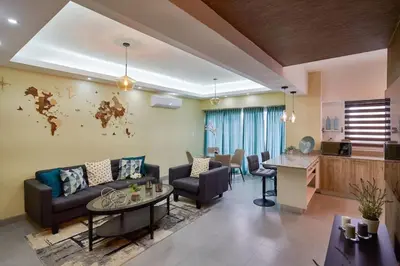 a living room with a couch and a table at Cozy City Center Condo, Full AC in Los Prados