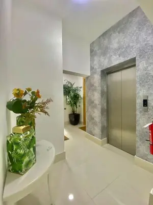 a hallway with a toilet with a vase of flowers at Cozy City Center Condo Full AC in Santo Domingo