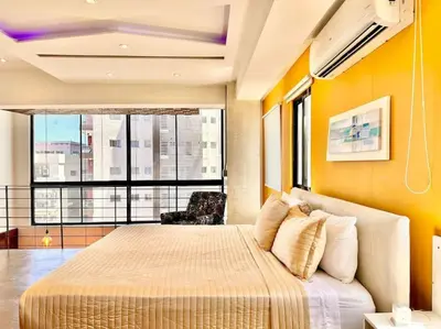 a bedroom with a large bed and a large window at New Loft Apt Full AC King Bed in Santo Domingo