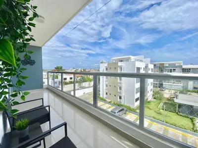 a balcony with a view of a city at Stylish Apt Full AC King Bed in Los Prados