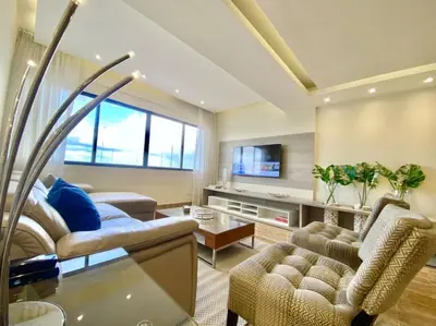 a living room with a couch and chairs and a table at Lovely Sto Dgo Center Apt in Santo Domingo