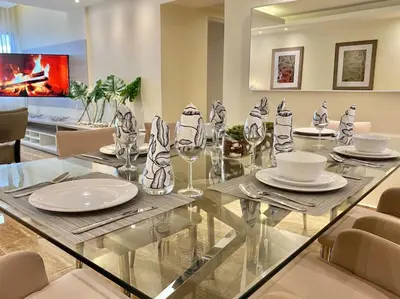 a dining room with a glass table and chairs at Lovely Sto Dgo Center Apt in Santo Domingo