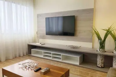 a living room with a television on a wall at Lovely Sto Dgo Center Apt in Santo Domingo