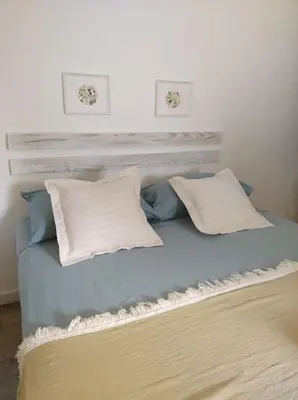 a bed with two pillows on top of it at Quédate Aquí in Las Galeras