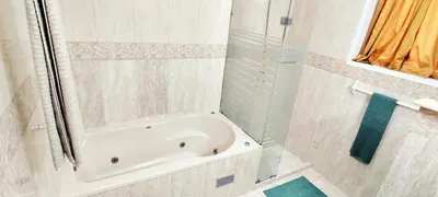 a white bathroom with a tub and a shower at Casa angelina in Sosúa