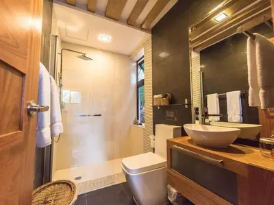 a bathroom with a toilet and a sink and a shower at RIBERAMAR Las Terrenas, Samana in Las Terrenas