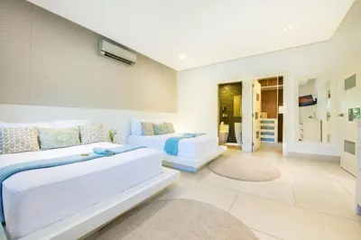 a living room with two beds and a couch at RIBERAMAR Las Terrenas, Samana in Las Terrenas